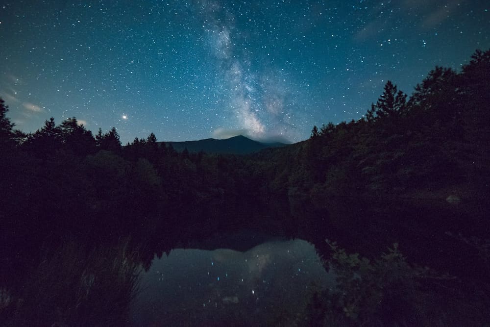 Mountain ridge under a star field at last light